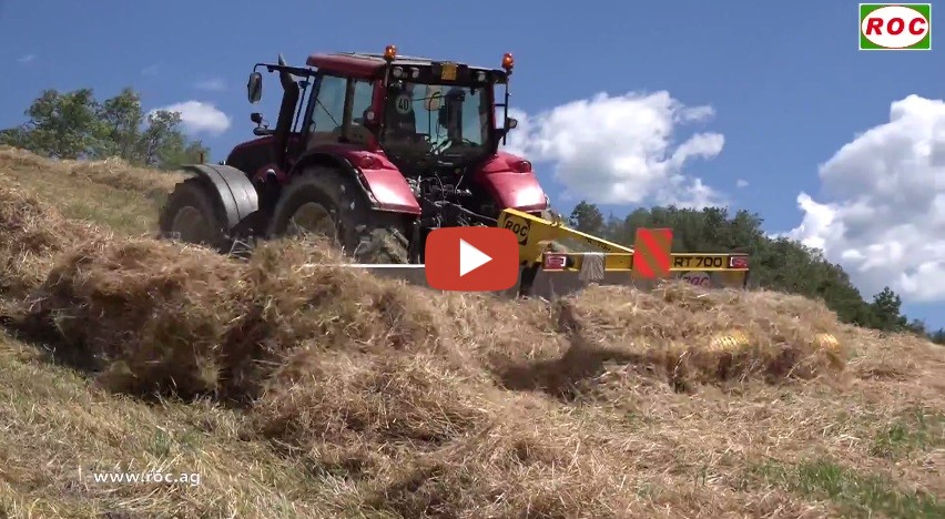 Raking backwards.The machine lifts the crop before the tractor's wheels ...