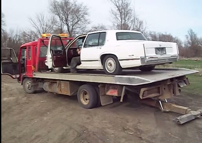 How not to unload a nice Cadillac Deville . Off a tow truck wrecker ...