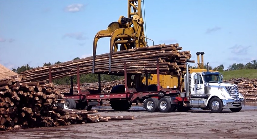 Log Stacker Unloading Tractor Trailer