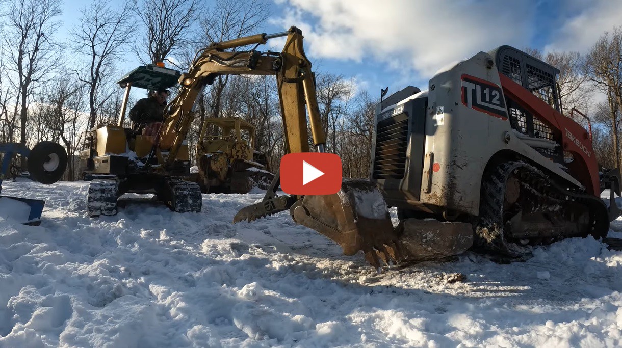 Andrew Camarata Installing a new set of tracks on a Takeuchi TL12